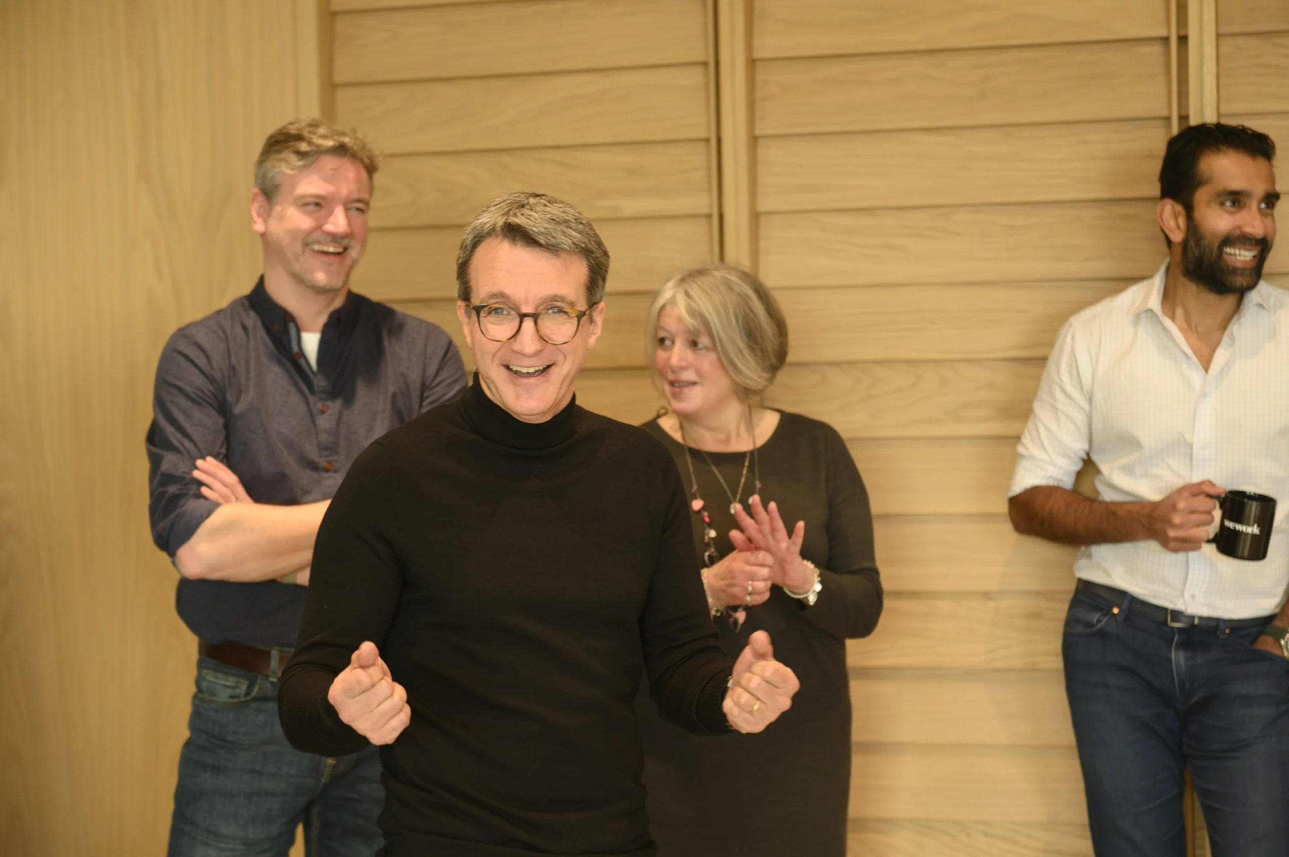 CEO Richard Mason getting excited and enthusiastic with team members behind him