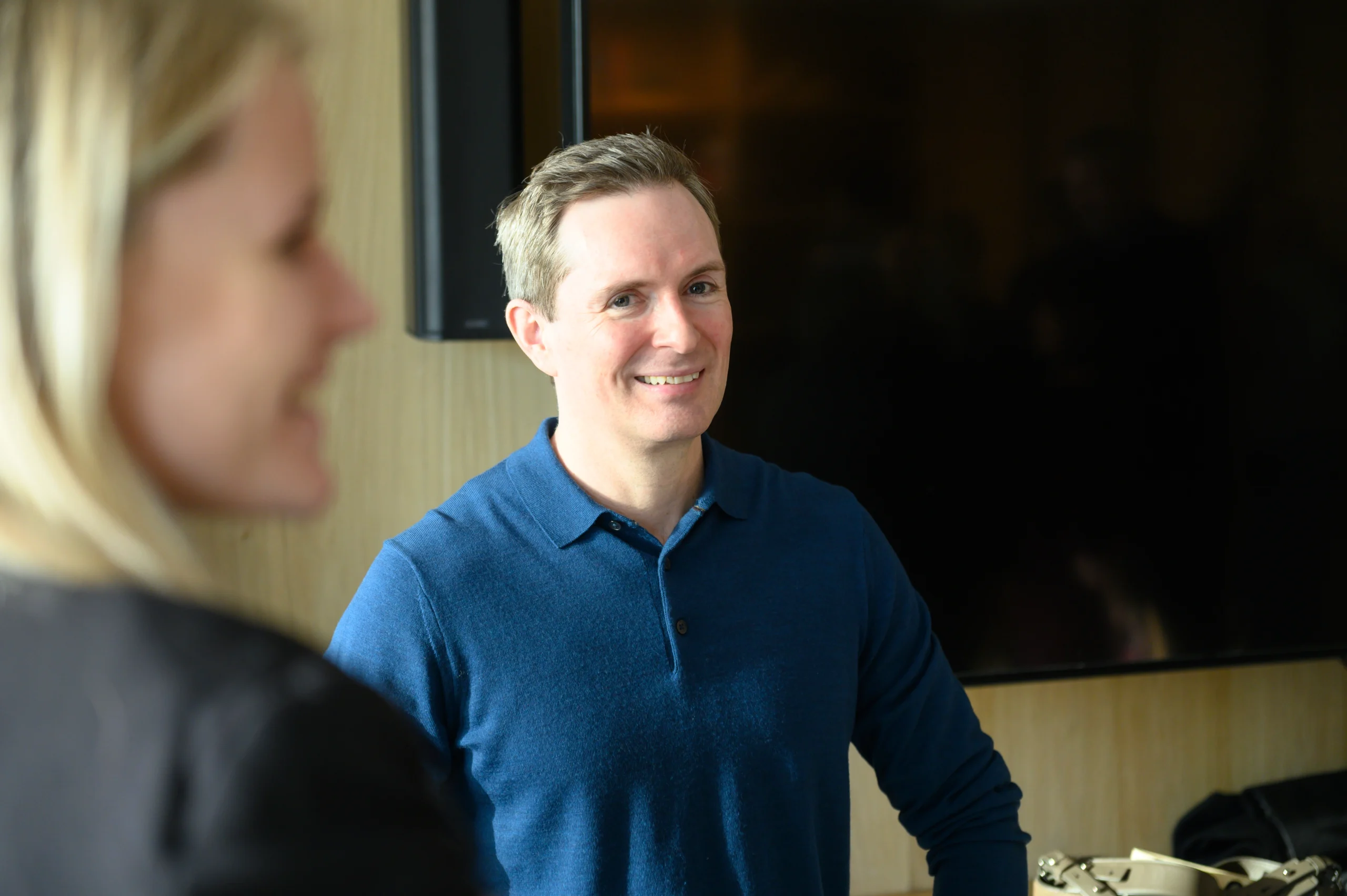 Smiling shot of a person with another in the foreground