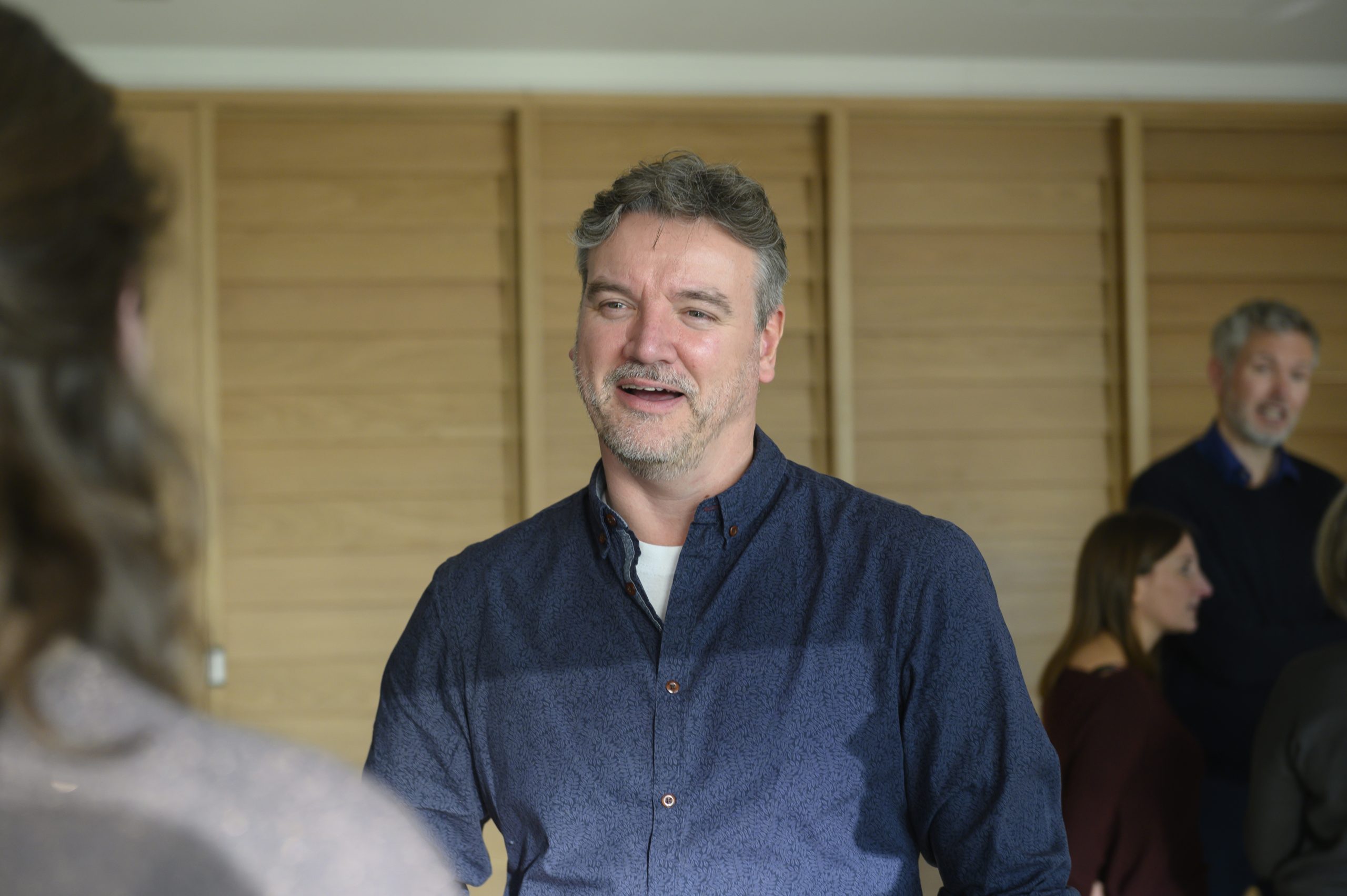 Person in an engaged conversation in a large room